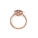 Rose gold ring with a light pink gemstones on a white background